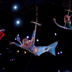 Three mermaids perform aerial acrobatics on anchors in Myrtle Beach, South Carolina. Located at Pirates Voyage Dinner & Show.