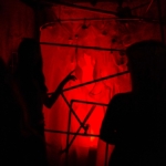 A creepy, red-lit room with pipes at Ripley's Haunted Adventure in Myrtle Beach, South Carolina.