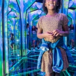 A child smiling in the mirror maze at Ripley's Mirror Maze in Myrtle Beach.
