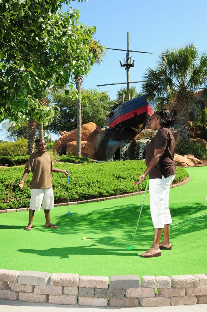 Mom and son playing miniature golf