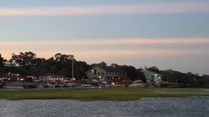 Murrells Inlet MarshWalk at dusk with waterfront restaurants and boats.