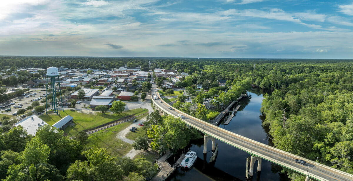Aerial view of Conway, South Carolina with the Waccamaw River and a bridge.