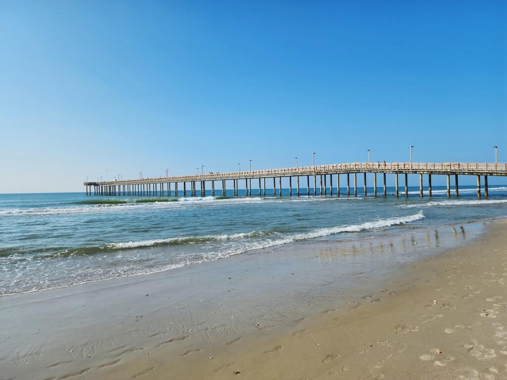 Myrtle Beach fishing pier stretching over the Atlantic Ocean with calm waves and sandy shoreline