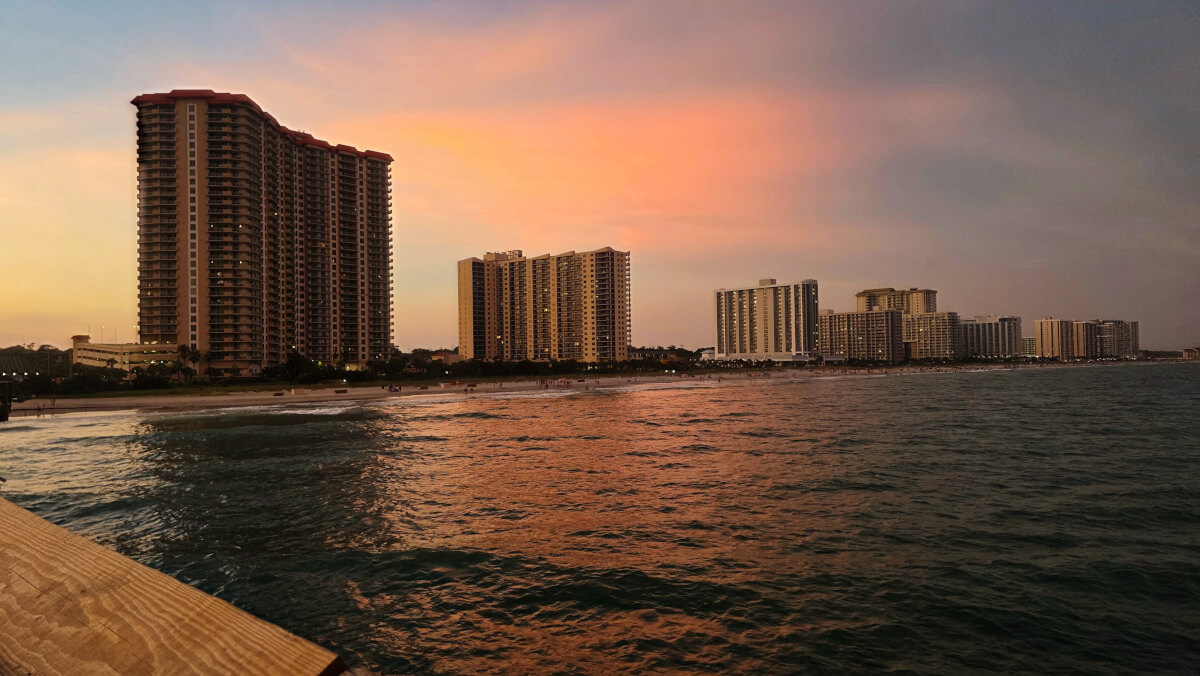 Oceanfront resorts along Myrtle Beach at sunset with colorful skies over the Atlantic Ocean