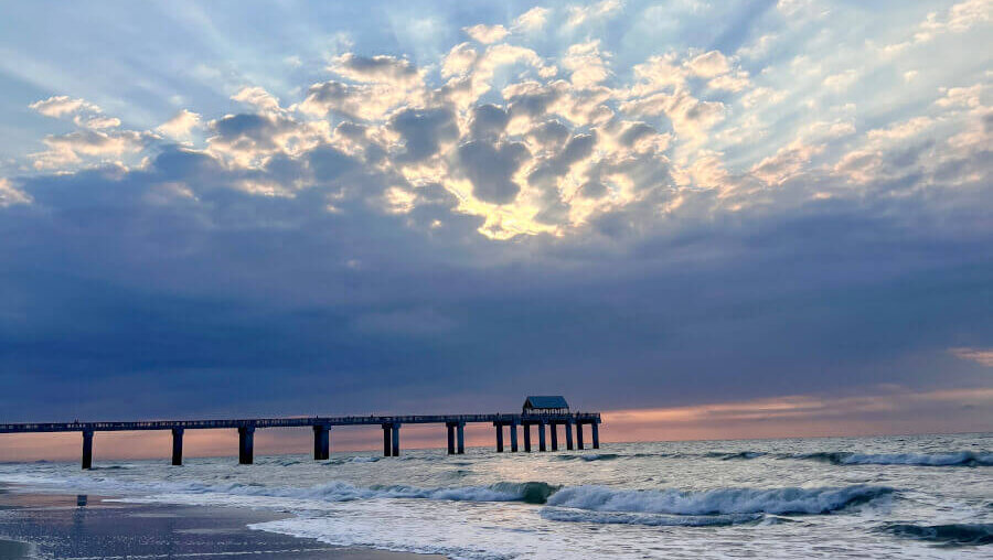 Surfside Beach Fishing Pier stretching over the Atlantic Ocean at sunrise