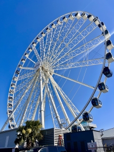 Myrtle Beach SkyWheel standing tall against a clear blue sky on the oceanfront boardwalk.