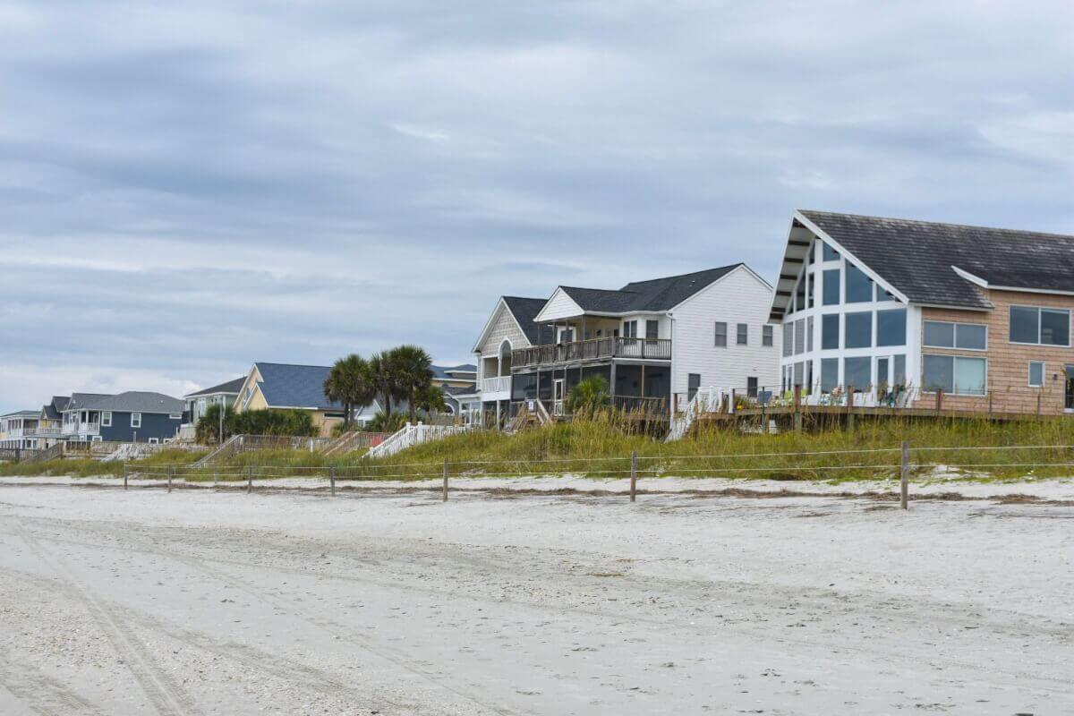 a row of houses on the beach during the off season