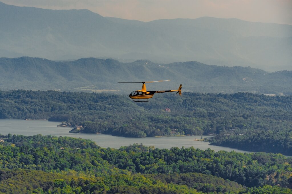 Yellow Scenic Helicopter Tours aircraft flying above the Smoky Mountains