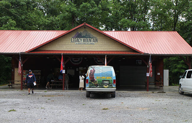 Legacy Mountain Zipline headquarters building in Gatlinburg with visitors preparing for their adventure.