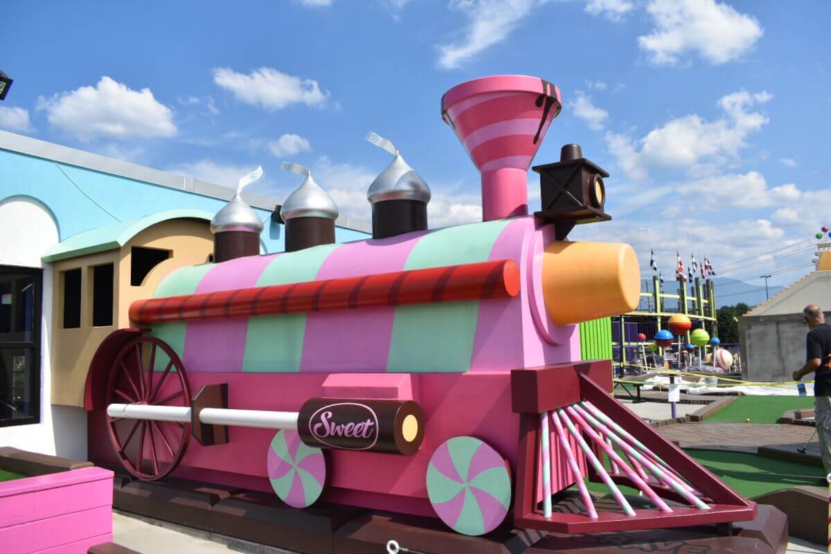 Colorful candy-themed train at Crave Golf Club mini golf in Pigeon Forge, Tennessee