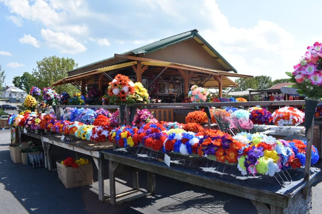 Colorful flower stands and outdoor vendor booths at the Great Smokies Flea Market in Kodak, Tennessee.