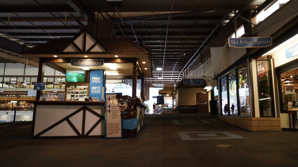 Inside Ober Mountain in Gatlinburg with local shops, an information booth, and ski-themed décor.