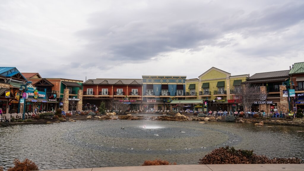 The Island in Pigeon Forge featuring shops, restaurants, and attractions beneath a bright blue sky.