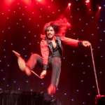 Performer does stunts on stage.