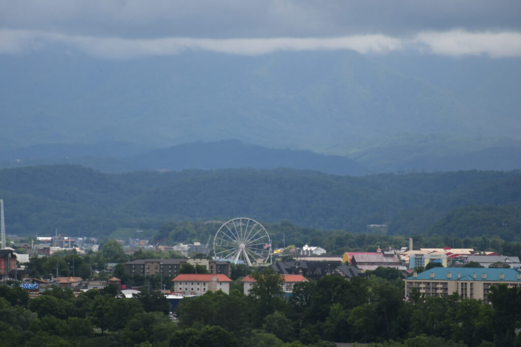 Mountain view over Pigeon Forge with the Ferris wheel and Smoky Mountains in the background