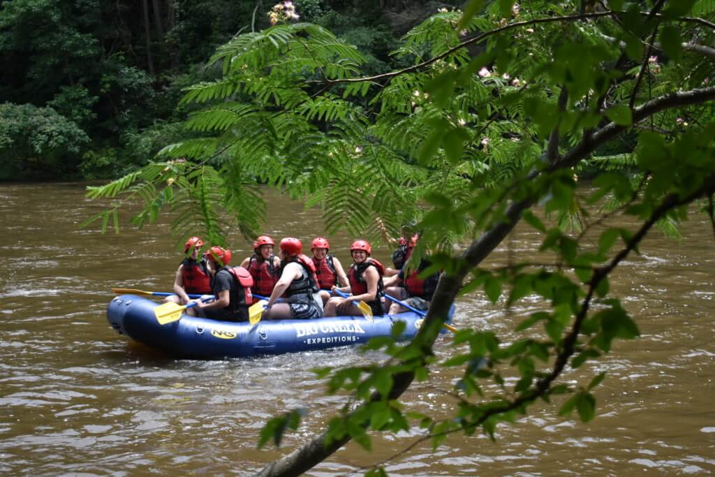 Rafting group floating with Big Creek Expeditions on the calmer Lower Pigeon River near the Smoky Mountains