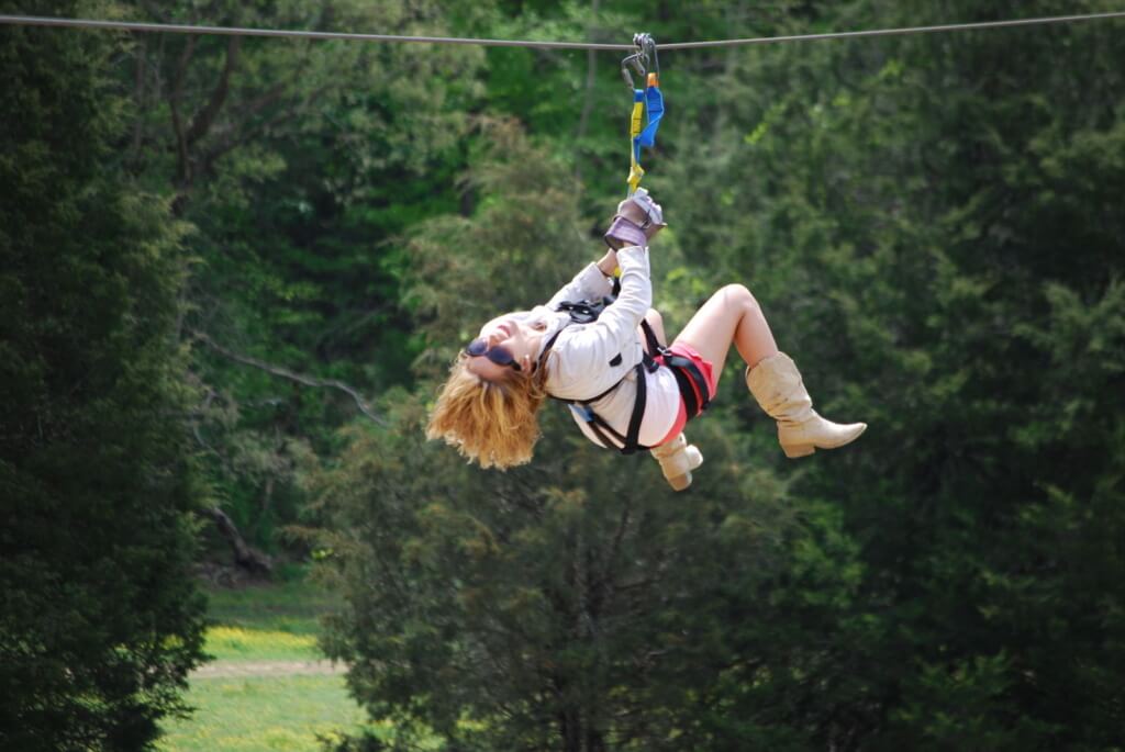 Woman ziplining at Jayell Ranch in Pigeon Forge during a Smoky Mountains adventure
