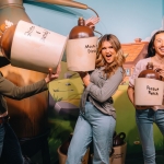 Three girls hold comically sized jugs at Ripley's Illusion Lab in Pigeon Forge, TN.