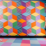 An optical illusion makes a woman appear larger than a man at Ripley's Illusion Lab