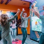 A family celebrate after winning a game at Ripley's Illusion Lab in Pigeon Forge, TN.