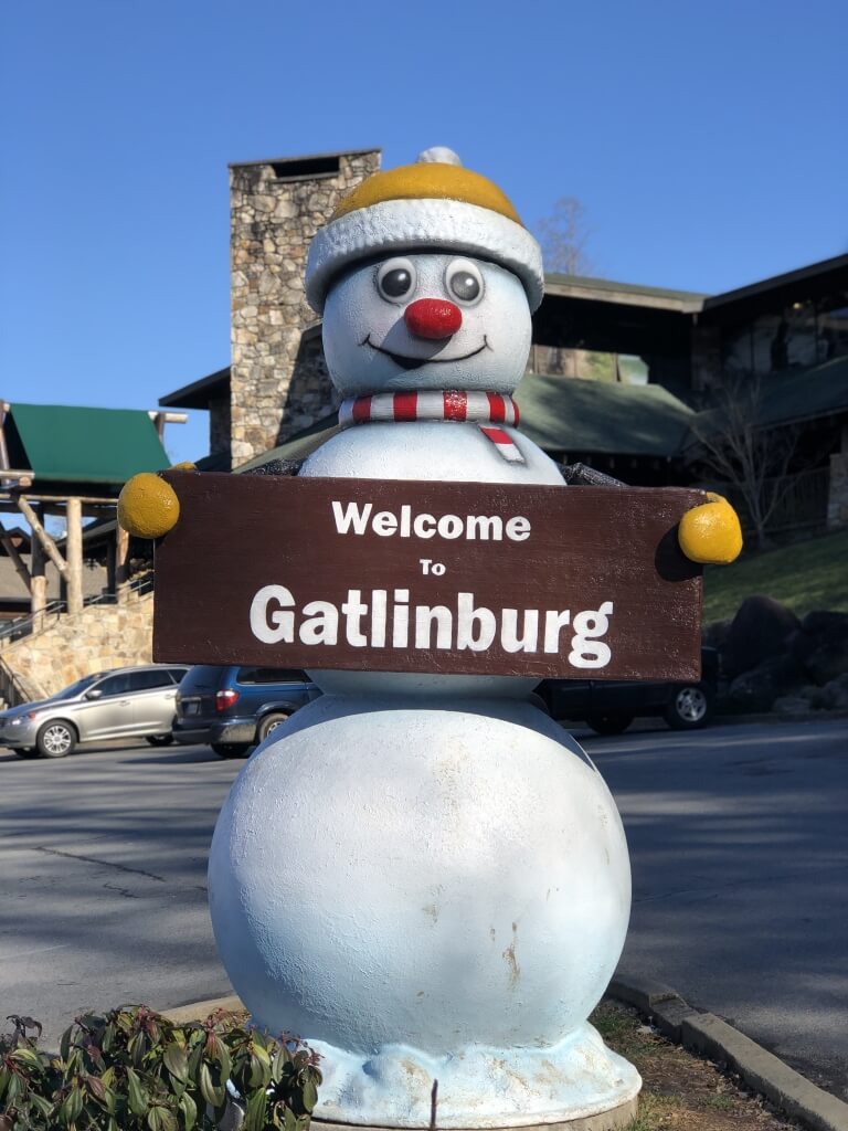 Welcome to Gatlinburg SnowPerson statue greeting visitors as part of the SnowPeople Scavenger Hunt in winter.