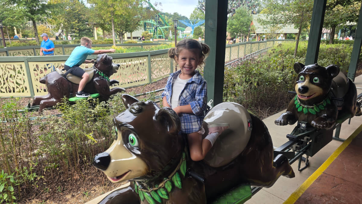 Young child riding a bear-themed kids attraction at Dollywood in Pigeon Forge