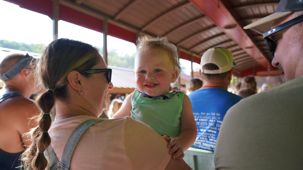 Toddler with parents at Dollywood in Pigeon Forge during a family trip to the Smoky Mountains