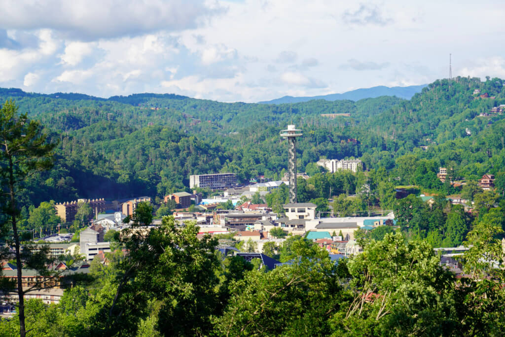 View of downtown Gatlinburg with the Space Needle surrounded by Smoky Mountain hills
